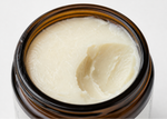 Formed Everyday Balm jar with lid removed exposing the smooth, creamy, tallow texture inside, sitting on a white background